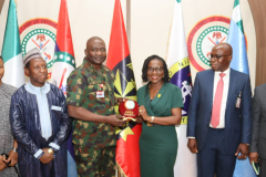DG NIALS Prof M T Ladan presenting to the Chief of Defence Staff (CDS) Gen. Chris Musa with NIALS latest publications during a courtesy visit by the permanent secretary/SGOF Mrs. Beatrice Jedy Agba who received a plaque from the CDS with members of the National IHL implementation committee including representatives of the NSA, and CDS at the Defence Hq Abuja. Tuesday 27th February 2024. 